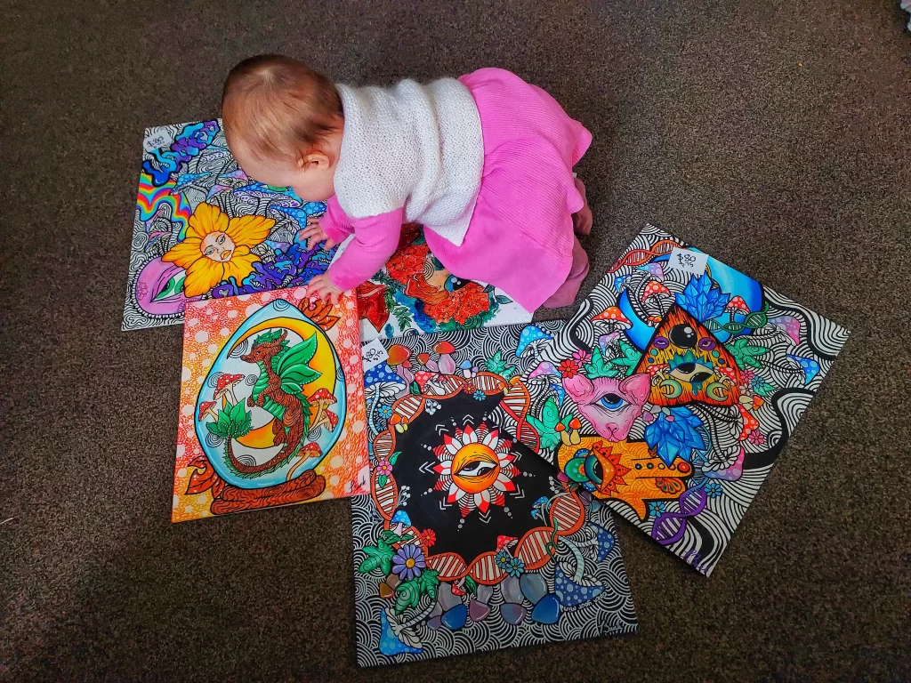 Tessa Zank Baby playing with her Arts, an artist from Coromandel New zealand